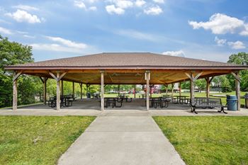 A covered picnic area with tables and chairs.